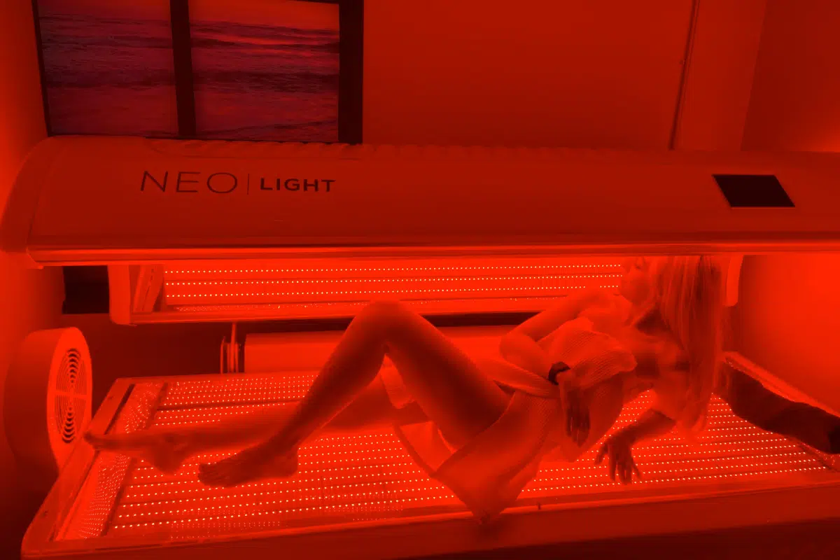 Woman in red light therapy bed