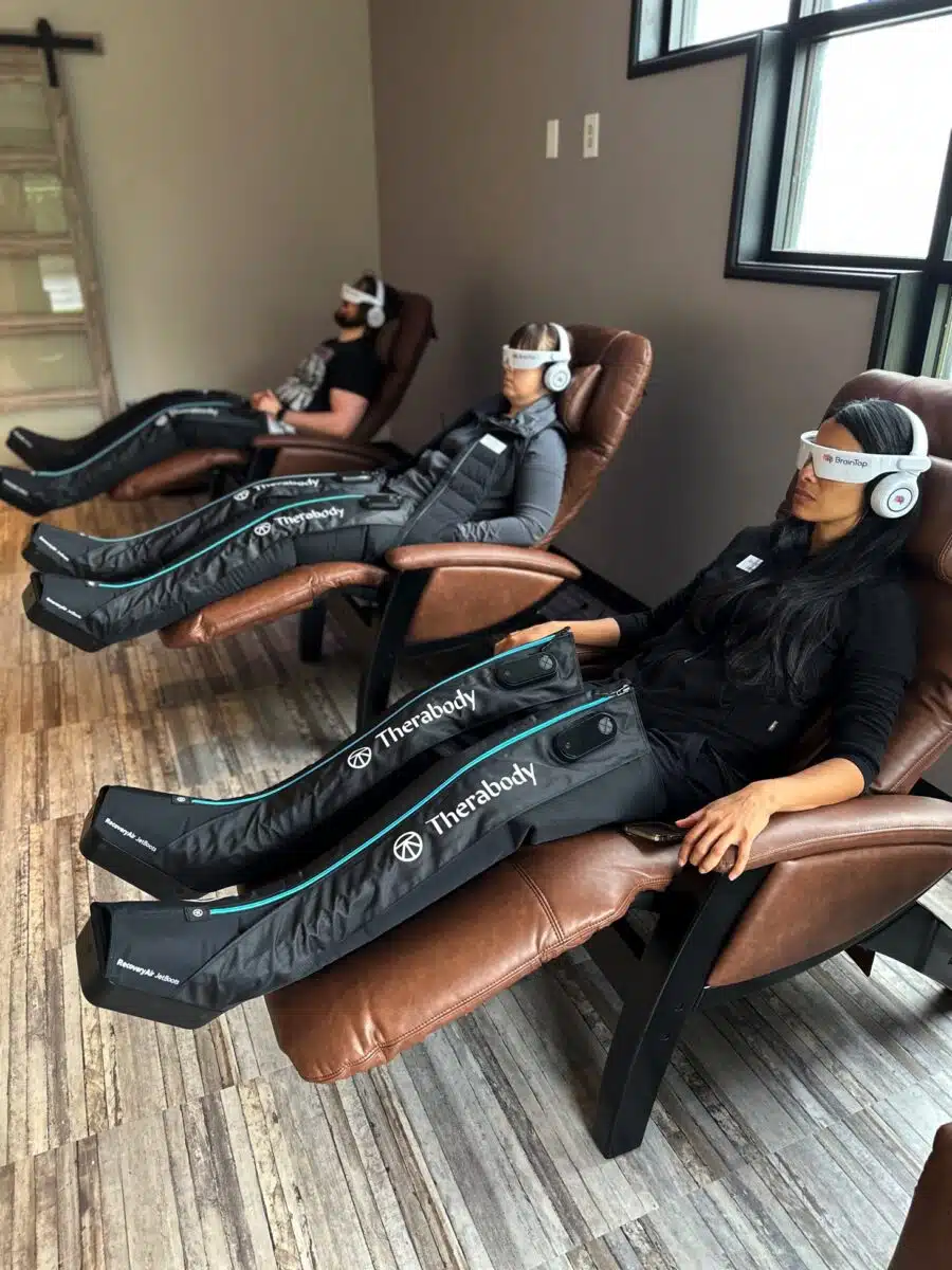 Three people getting compression Therapy in chairs.