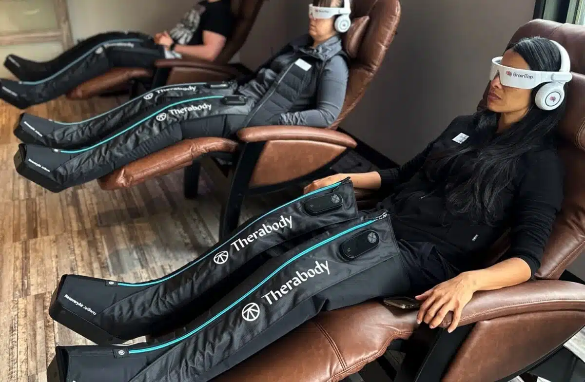 Three people using compression boots at 212