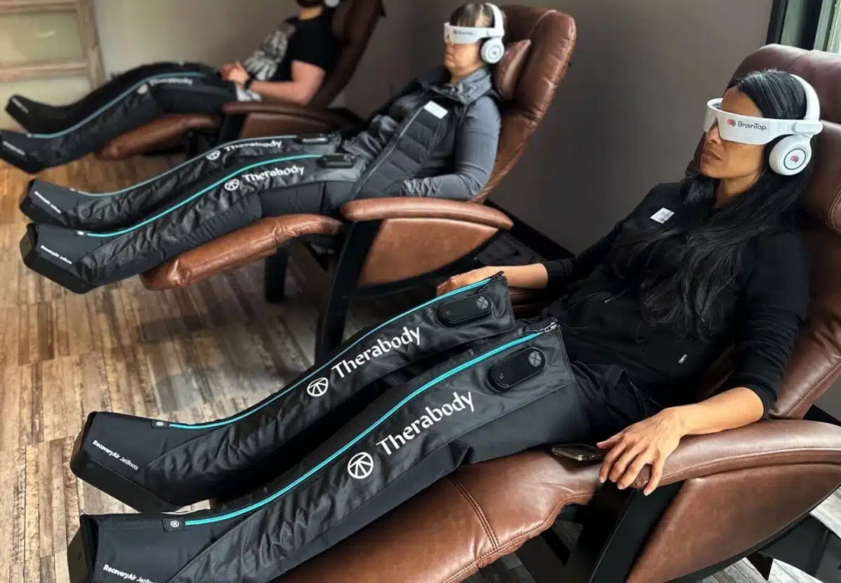 Three people using compression boots at 212