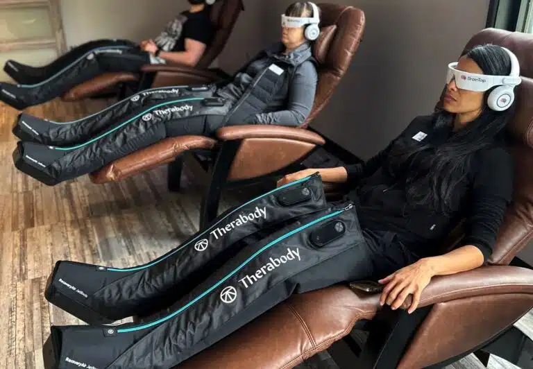 Three people using compression boots at 212