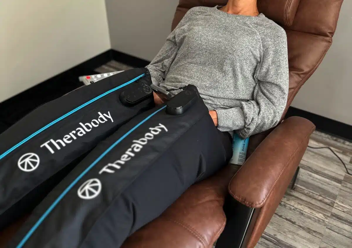 Woman using compression boots at 212 Med Spa