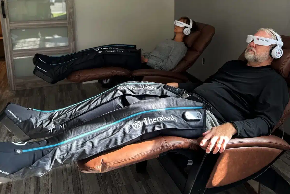 Two people using compression boots at 212 Med Spa in Edmonds