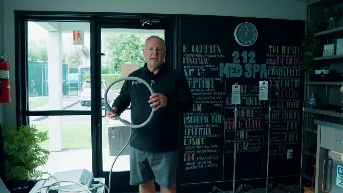 Greg holding PEMF tool at 212 Med Spa