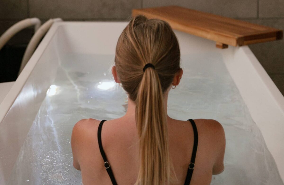 Woman sitting in a cold plunge